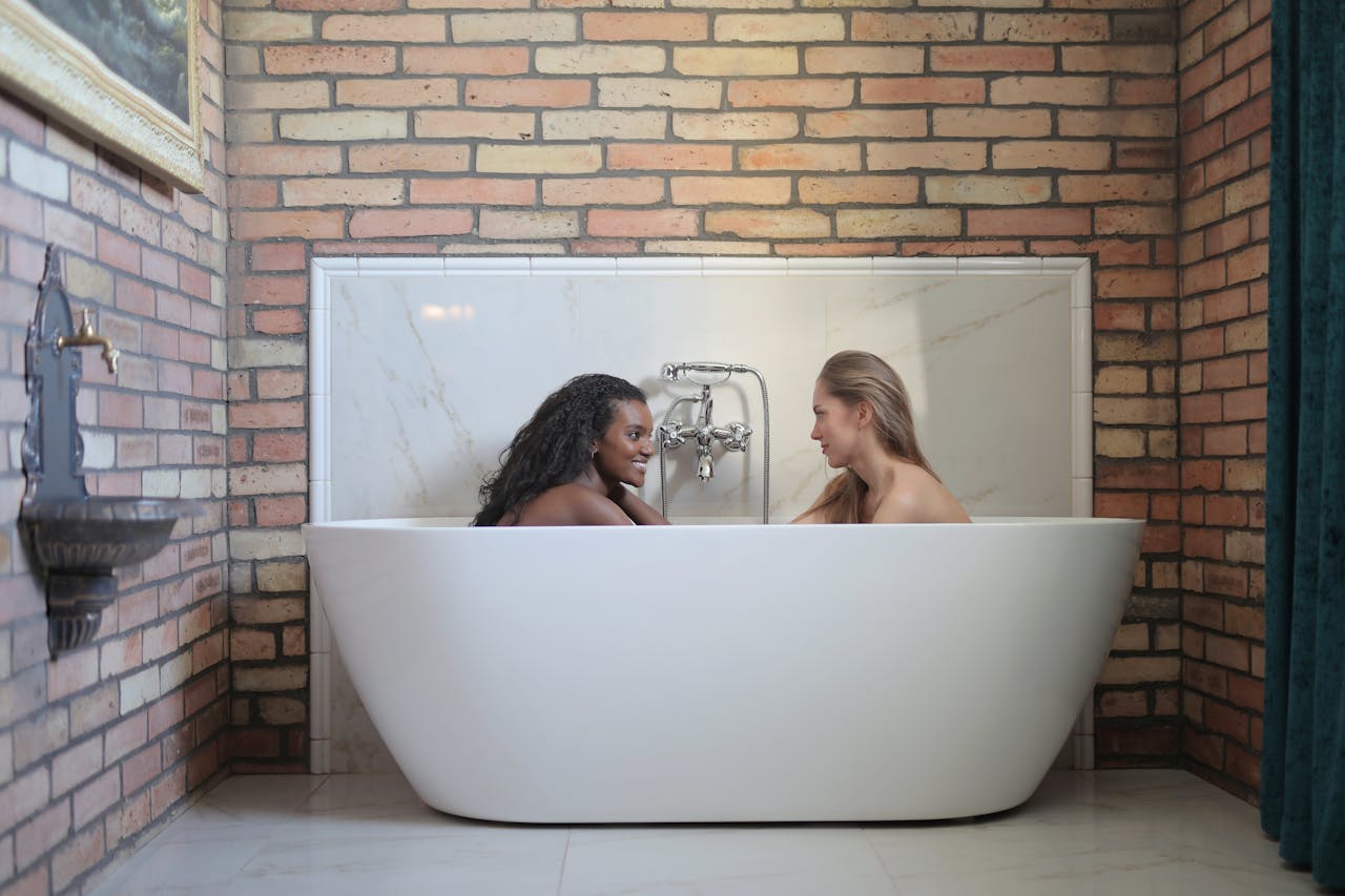 Two women enjoying a relaxing bath in a stylish modern bathroom.